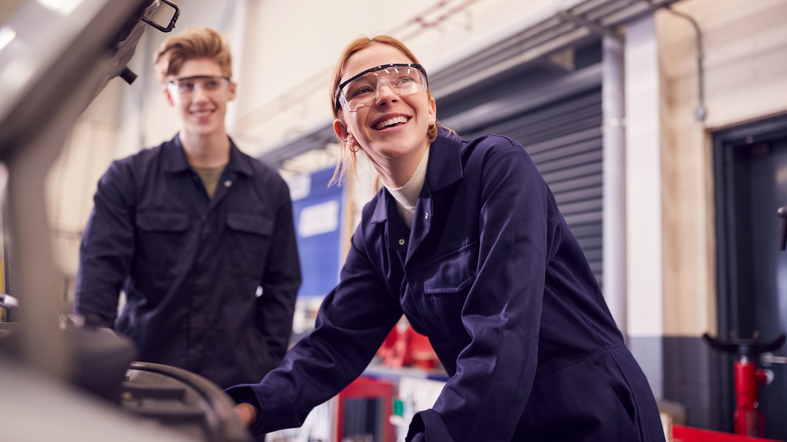 null Automobilfachmann und Automobilfachfrau arbeiten an Auto